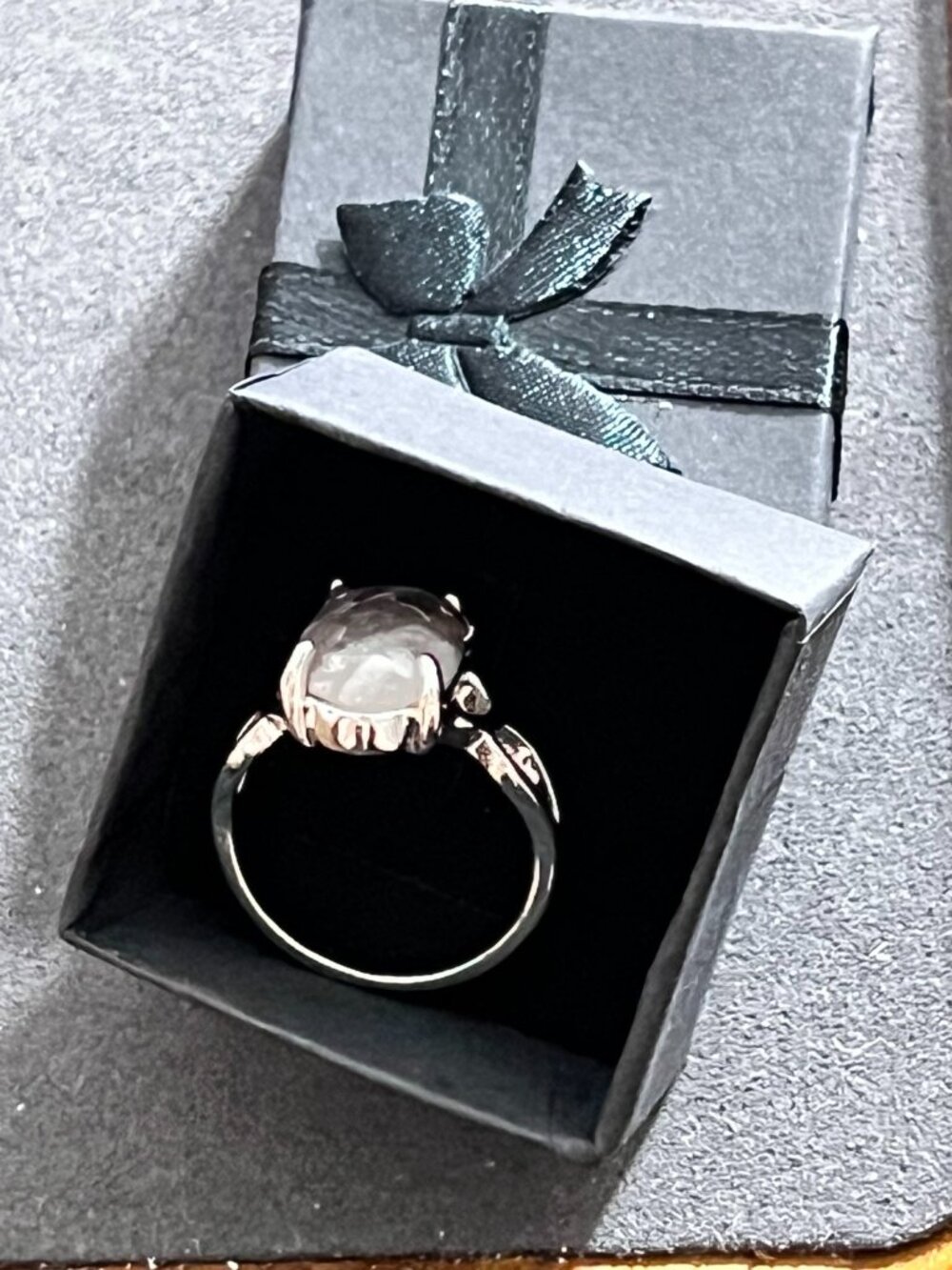 Elegant silver-tone statement ring featuring a faceted oval pale-pink ston
